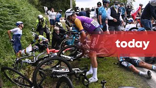 Spectator with signboard causes massive crash at Tour de France [upl. by Acinelav]